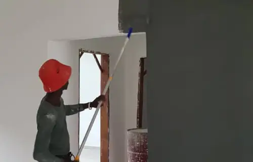 Pabi's Painting expert transforming a bedroom with fresh, vibrant colors during an interior painting project in The Gambia